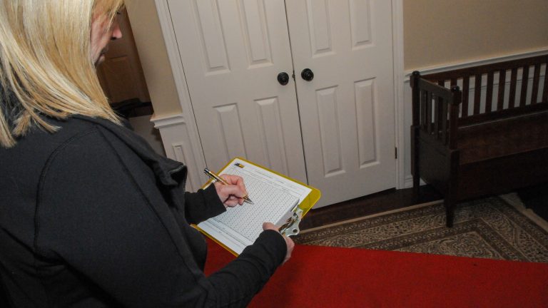 Woman checking something on a clipboard