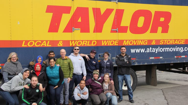 Taylor Moving staff next to a moving truck
