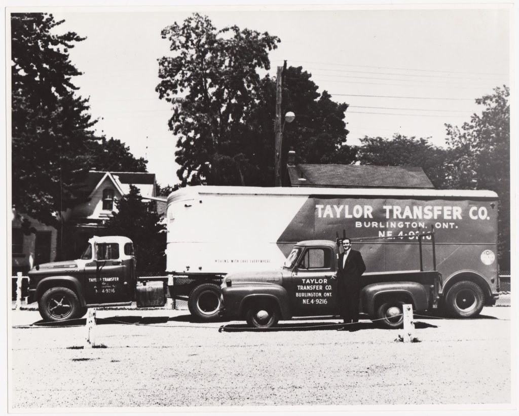 Al Taylor standing in front of a moving truck