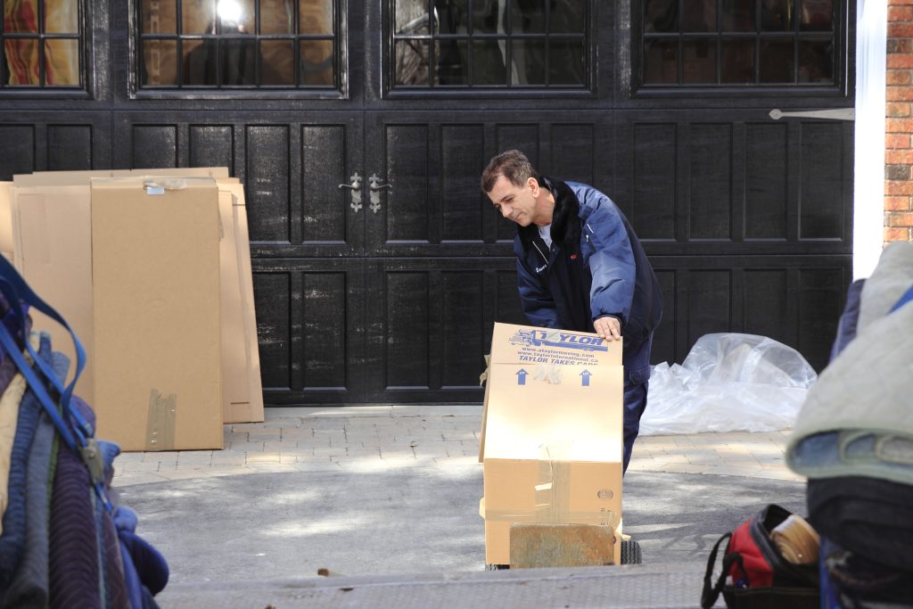 Man loading box into moving truck