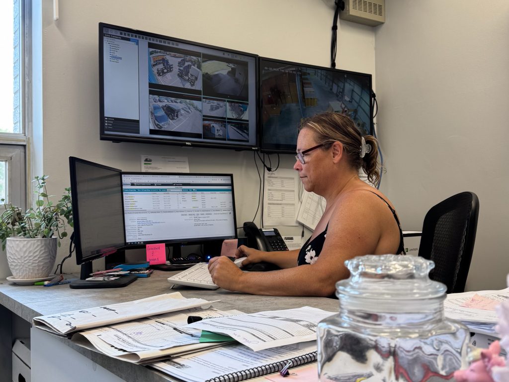 Woman sitting at a desk typing on a computer